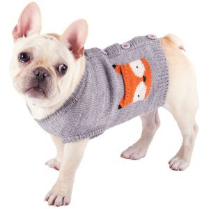 A dog wearing a sweater with an animal on it.