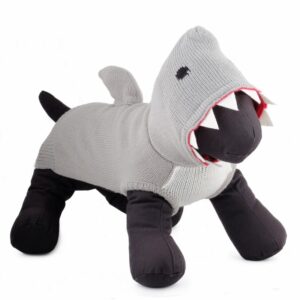 A stuffed shark is standing up and looking at the camera.