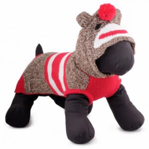 A stuffed animal dog wearing a sweater.