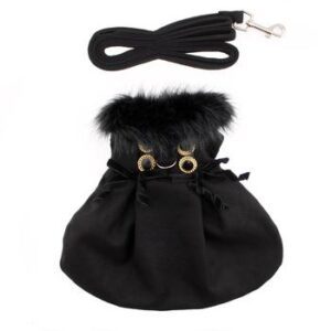 A black purse with fur on it and a leash.