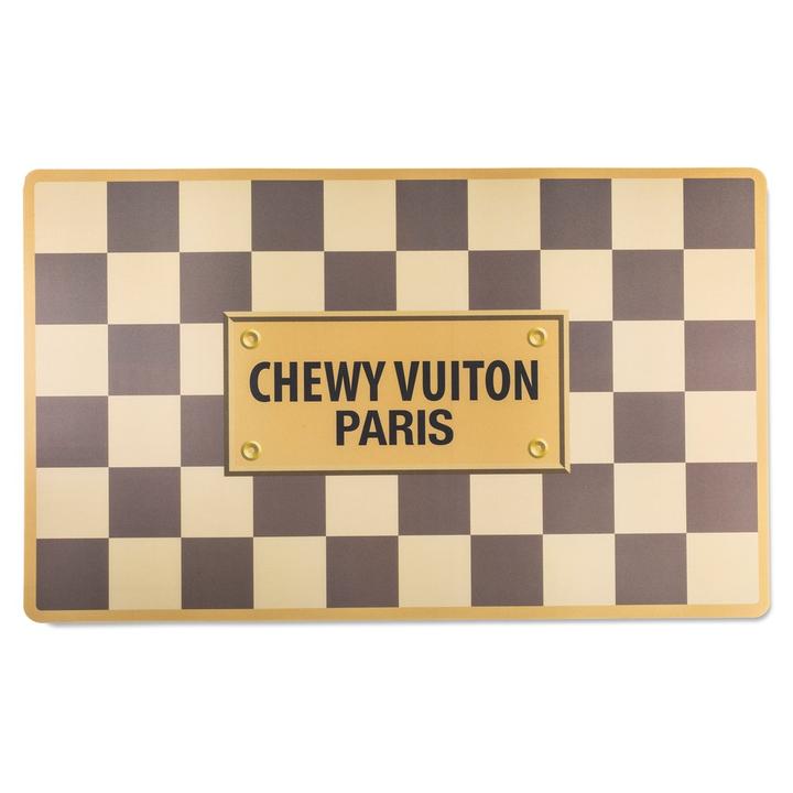 A black and white checkered mat with the words chewy vuitton paris on it.