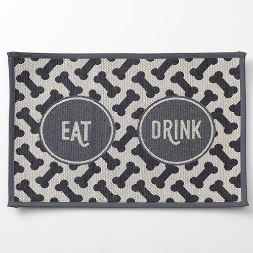 A black and white mat with the words " eat drink ".