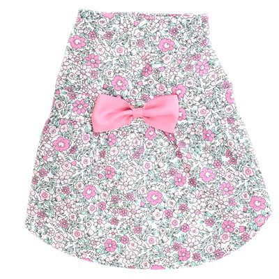 A pink bow on the front of a dress.