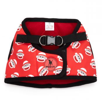 A red and white dog harness with monkey faces on it.