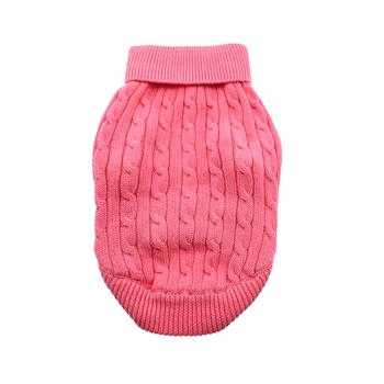 A pink sweater is sitting on the floor.