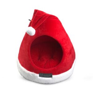 A red and white cat bed with a santa hat on it