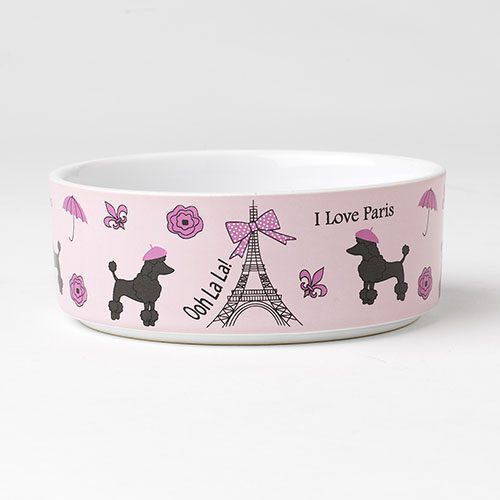 A pink bowl with black and white dogs on it