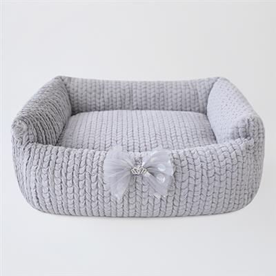 A dog bed with a bow on it