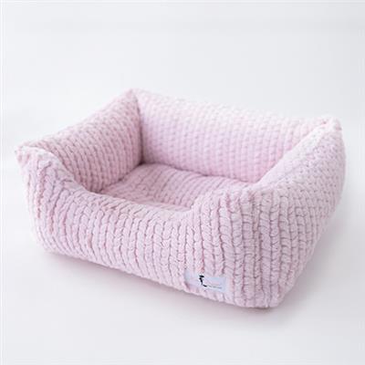 A pink dog bed with a white background