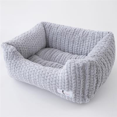 A dog bed that is made of knitted fabric.