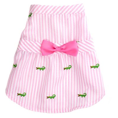 A pink striped dress with a bow on the front.