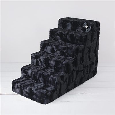 A black dog bed with stairs on it