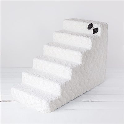 A white stair case with two eyes on it.