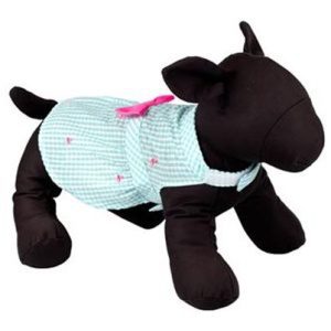 A black dog wearing a blue shirt and pink bow.