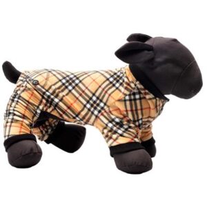 A stuffed lamb in pajamas is sitting on the floor.