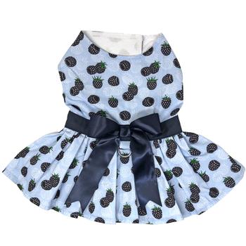 A blue dress with black and white apples on it.