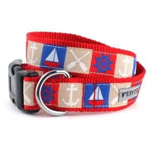 A red and blue dog collar with a sailboat design.