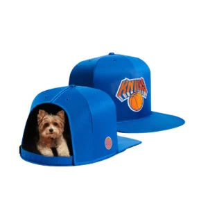 A dog sitting inside of a hat.